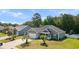 Charming home with manicured front yard, a two-car garage, and mature trees enhancing its curb appeal at 247 Dempsey Dr., Loris, SC 29569