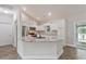 A modern kitchen equipped with white cabinets, granite countertops, and stainless-steel appliances at 247 Dempsey Dr., Loris, SC 29569