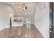 Open-concept living area with hardwood floors, vaulted ceilings, and a view of the modern kitchen and sliding glass doors at 247 Dempsey Dr., Loris, SC 29569