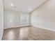 Open living room with vaulted ceilings, entry door, and large window at 247 Dempsey Dr., Loris, SC 29569