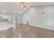 Bright, open-concept living space with high ceilings, and kitchen area in the background at 247 Dempsey Dr., Loris, SC 29569