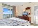 Bright bedroom with ocean view balcony, dresser, and TV for relaxing coastal living at 2501 S Ocean Blvd. # 831, Myrtle Beach, SC 29577