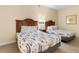 Comfortable bedroom featuring two beds with white linens and dark wooden headboards, creating a relaxing space at 2501 S Ocean Blvd. # 831, Myrtle Beach, SC 29577