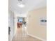 Tile hallway leading to open living area with balcony access and dining table at 2501 S Ocean Blvd. # 831, Myrtle Beach, SC 29577