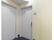 Hallway view with white doors, unit number 831, blue carpet, and pale-yellow walls at 2501 S Ocean Blvd. # 831, Myrtle Beach, SC 29577