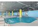 Indoor pool with yellow pillars, blue walls, and dark ceiling in the community center at 2501 S Ocean Blvd. # 831, Myrtle Beach, SC 29577