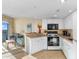 Cozy kitchen next to living area featuring white cabinets and granite countertops at 2501 S Ocean Blvd. # 831, Myrtle Beach, SC 29577
