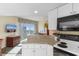Kitchen view of bar-top overlooking living area with TV and ocean view at 2501 S Ocean Blvd. # 831, Myrtle Beach, SC 29577
