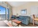 Cozy living room featuring comfortable seating and a sliding door to the balcony with ocean view at 2501 S Ocean Blvd. # 831, Myrtle Beach, SC 29577