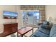 Inviting living room with a TV, wooden furniture, and sliding glass doors leading to the balcony at 2501 S Ocean Blvd. # 831, Myrtle Beach, SC 29577