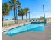 Outdoor pool with multiple lounge chairs and palm trees in the community area at 2501 S Ocean Blvd. # 831, Myrtle Beach, SC 29577