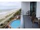 Balcony overlooking the ocean and pool with chairs at 3000 Ocean Blvd. N # 508, Myrtle Beach, SC 29577