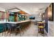 Modern bar with dark seating, tile floors, and sports on TV at 3000 Ocean Blvd. N # 508, Myrtle Beach, SC 29577