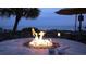 Outdoor fire pit and lounge area with a stunning view of the ocean at dusk at 3000 Ocean Blvd. N # 508, Myrtle Beach, SC 29577