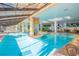 Large indoor pool area with vibrant murals, plants, and a relaxing atmosphere at 3000 Ocean Blvd. N # 508, Myrtle Beach, SC 29577
