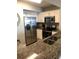 Modern kitchen with stainless steel appliances, granite countertops and white cabinets at 3000 Ocean Blvd. N # 508, Myrtle Beach, SC 29577
