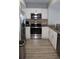 Modern kitchen with stainless steel appliances, granite countertops, and white cabinetry at 3000 Ocean Blvd. N # 508, Myrtle Beach, SC 29577