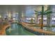Indoor lazy river with tropical decor, murals, and a shallow winding stream at 3000 Ocean Blvd. N # 508, Myrtle Beach, SC 29577
