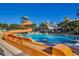 A resort-style pool has a twisting water slide and many lounge chairs at 3000 Ocean Blvd. N # 508, Myrtle Beach, SC 29577