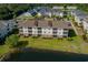 An aerial view of a lakeside condo featuring manicured lawn and screened porches at 334 Kiskadee Loop # 18-L, Conway, SC 29526