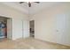 Neutral-toned bedroom with ceiling fan, closet, and doorway to bathroom at 334 Kiskadee Loop # 18-L, Conway, SC 29526