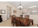 Dining area features a wooden table with six chairs, neutral walls, and stylish chandelier at 334 Kiskadee Loop # 18-L, Conway, SC 29526
