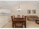 Dining room open to kitchen and living area with wooden table and chandelier at 334 Kiskadee Loop # 18-L, Conway, SC 29526