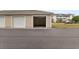 A tan detached garage with open door providing parking and storage space at 334 Kiskadee Loop # 18-L, Conway, SC 29526