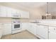 Bright kitchen featuring white appliances, cabinets, and tile flooring at 334 Kiskadee Loop # 18-L, Conway, SC 29526