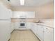 Bright kitchen featuring white appliances, cabinets, and tile flooring at 334 Kiskadee Loop # 18-L, Conway, SC 29526