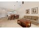 Living and dining area with neutral carpeting, wooden table, sofa and adjacent kitchen at 334 Kiskadee Loop # 18-L, Conway, SC 29526
