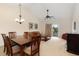Open-concept living and dining area featuring a vaulted ceiling and neutral carpeting throughout at 334 Kiskadee Loop # 18-L, Conway, SC 29526