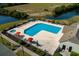 Aerial view of a refreshing pool area complete with lounge chairs, umbrellas, and a hot tub at 334 Kiskadee Loop # 18-L, Conway, SC 29526