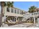 Back exterior of waterfront home with deck, outdoor furniture, ceiling fans, string lights, and staircase at 337 59Th Ave. N, North Myrtle Beach, SC 29582