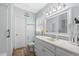Well-lit bathroom featuring a white vanity, framed mirror, and neutral wall color at 337 59Th Ave. N, North Myrtle Beach, SC 29582