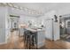 Well-lit kitchen with white cabinets, stainless steel appliances, and breakfast bar at 337 59Th Ave. N, North Myrtle Beach, SC 29582