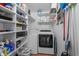 Laundry room with white washer and dryer surrounded by shelves at 337 59Th Ave. N, North Myrtle Beach, SC 29582