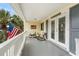 Inviting porch with rocking chairs, an American flag, and double doors at 337 59Th Ave. N, North Myrtle Beach, SC 29582