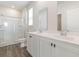 A sleek, modern bathroom with double sinks, white cabinets and a glass-enclosed shower at 376 Black Pearl Way, Myrtle Beach, SC 29588