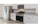 Modern kitchen with stainless steel appliances, granite countertops, and white cabinetry at 376 Black Pearl Way, Myrtle Beach, SC 29588