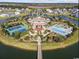 An aerial view shows the pool and tennis courts on an island in a neighborhood at 404 Plantation Oaks Dr., Myrtle Beach, SC 29579
