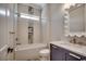 Charming bathroom with vanity, undermount sink, decorative mirror, and tile shower at 404 Plantation Oaks Dr., Myrtle Beach, SC 29579