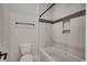 Bright bathroom features marble tiling, a built-in shelf, and a shower and bath combo at 404 Plantation Oaks Dr., Myrtle Beach, SC 29579