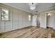 Stylish bedroom with hardwood floors, natural lighting, and a sliding barn door to the bathroom at 404 Plantation Oaks Dr., Myrtle Beach, SC 29579
