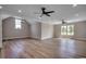 Large bonus room featuring hardwood floors, dual ceiling fans, and plenty of natural light at 404 Plantation Oaks Dr., Myrtle Beach, SC 29579