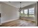 Dining room featuring beautiful hardwood floors, natural light, and a chandelier lighting fixture at 404 Plantation Oaks Dr., Myrtle Beach, SC 29579