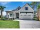 Charming two-story home with a well-manicured lawn, two-car garage, and inviting front porch at 404 Plantation Oaks Dr., Myrtle Beach, SC 29579