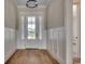 Inviting home foyer with elegant trim work, paneled walls, and a glass-paneled front door at 404 Plantation Oaks Dr., Myrtle Beach, SC 29579