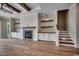 Spacious living room with a fireplace, wooden beams, custom shelving, and hardwood floors at 404 Plantation Oaks Dr., Myrtle Beach, SC 29579