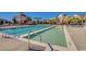 A resort style pool surrounded by lounge chairs and buildings with beautiful architecture at 404 Plantation Oaks Dr., Myrtle Beach, SC 29579